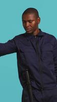 Vertical Security guard pointing finger at people to prevent them from gaining access in restricted areas. Portrait of stern bodyguard scolding and telling off unwanted visitors, studio background, camera B video