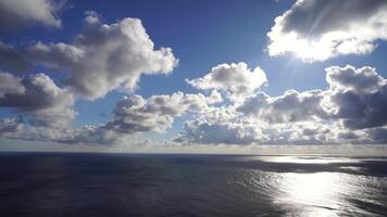 Aerial view. Dramatic sunset with sea and gloomy clouds. Abstract aerial nature summer ocean sunset sea and sky background. Horizon. Vacation, travel and holiday concept. Weather and climate change video