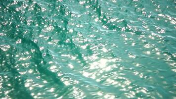Sea water surface. Low angle view over clear azure sea water. Sun glare. Abstract nautical summer ocean nature. Holiday, vacation and travel concept. Nobody. Slow motion. Weather and climate change video