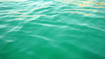 Sea water surface. Low angle view from kayak, camera flies over clear sea water. Nobody. Holiday recreation concept. Abstract nautical summer ocean nature. Slow motion. Close up. Vertical video