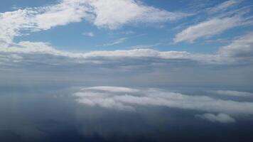 Aerial view. Blue sky sun and fog over calm sea. The drone flies over foggy and fluffy clouds. Abstract aerial nature summer ocean sunset sea and sky background. Vacation, travel and holiday concept. video