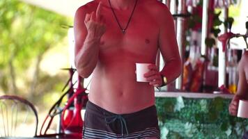 Close up of Man Showing Fuck You. Unrecognizable man showing someone extremely offensive expression in beach cafe. video