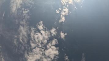 Timelapse fluffy Cumulus clouds moving in bright sunset sky. Abstract aerial nature summer ocean sunset, sea and sky view. Vacation, travel, holiday concept. Weather and Climate Change video