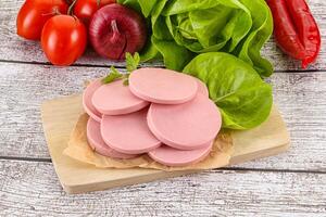 Slices boiled sausages for breakfast photo