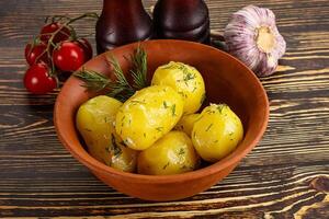 Boiled potato with oil and dill photo