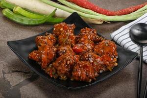Manchurian chicken with sauce and spices photo
