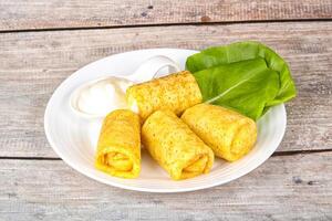 Stuffed pancakes with cream sauce photo