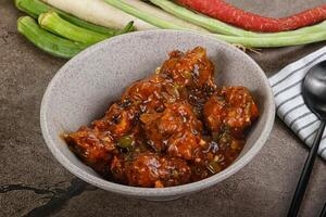 Manchurian chicken with sauce and spices photo