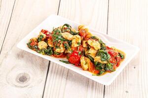 Chicken with tomato and spinach photo