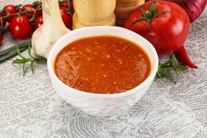 Hot tomato soup with diced chicken photo