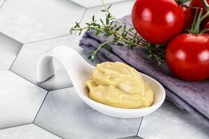 Dijon mustard sauce in the bowl photo