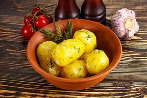 Boiled potato with oil and dill photo