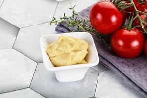 Dijon mustard sauce in the bowl photo