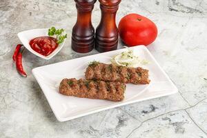 Kebab with beef served onion photo