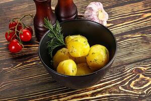 Boiled potato with oil and dill photo