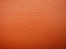 Close-up leather with a smooth, slightly uneven texture. photo