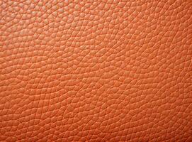 Close-up leather with a smooth, slightly uneven texture. photo