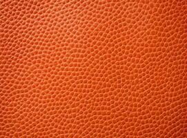 Close-up leather with a smooth, slightly uneven texture. photo
