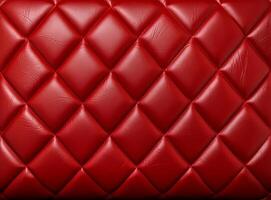 Luxurious red leather material with a classic diamond stitching pattern. photo