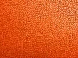 Close-up leather with a smooth, slightly uneven texture. photo