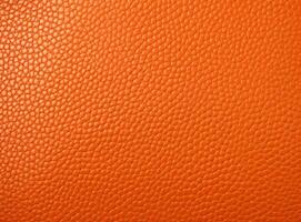 Close-up leather with a smooth, slightly uneven texture. photo