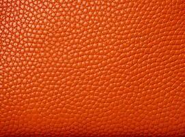 Close-up leather with a smooth, slightly uneven texture. photo
