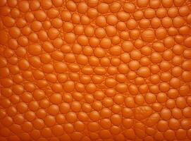 Close-up leather with a smooth, slightly uneven texture. photo