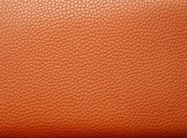 Close-up leather with a smooth, slightly uneven texture. photo
