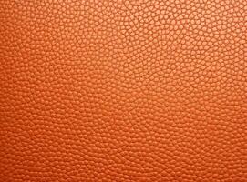 Close-up leather with a smooth, slightly uneven texture. photo