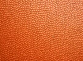 Close-up leather with a smooth, slightly uneven texture. photo