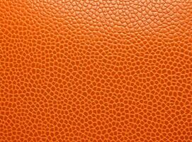Bright orange leather texture with a slightly worn surface. photo