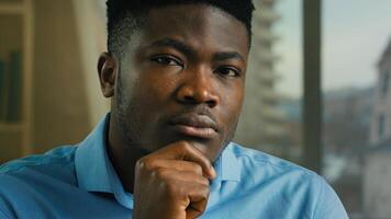 Head shot African American man ethnic thoughtful businessman think hold hand on chin doubt decision challenge solving business idea looking at camera nod head decide solution accept strategy support photo