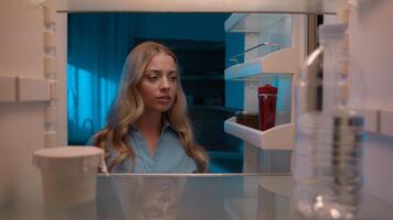Point of view POV inside refrigerator Caucasian girl hungry woman open fridge at home kitchen look at empty shelves order food products delivery with mobile phone app online service web store shopping photo
