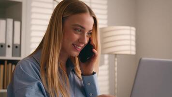 Caucasian girl talk to client on cellphone use laptop discuss deal woman businesswoman consultant agent at home office working with computer make order consultation support customer talking phone call photo