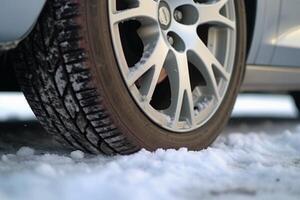 Winter tire covered in snow snowy road ice icy car wheel drive safety safe driving transportation condition change vehicle auto slippery danger frost protection climate dangerous offroad photo
