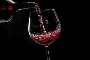 Pouring red wine to glass party restaurant bar gourmet celebration luxury taste splashing grape alcohol expensive drink bordeaux chateu cabernet bottle refreshment toned drops bubbles photo