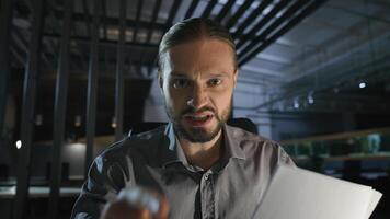 Web cam view conference distant online call conflict quarrel problem communication webcam male businessman argue talk speak at camera hold bad papers documents in dark office business man angry photo