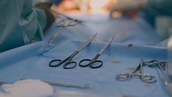 Close up multiple surgery tools on table in operating room team surgeons doctors perform medical operation using scalpels forceps scissors surgical instruments modern medicine health care in hospital photo