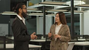 Divers business partners workers multiethnic colleagues Indian man Arabian businessman talk Asian woman employer Korean businesswoman discuss talking happy smiling conversation friendly in office photo