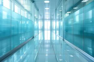 A large, empty office room with a sun shining through the windows. Modern space is made of glass and has a shiny, reflective surface photo