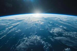 A view of the Earth from space, with a bright blue planet surrounded by a dark sky. The stars are scattered throughout the sky, creating a sense of vastness and wonder photo