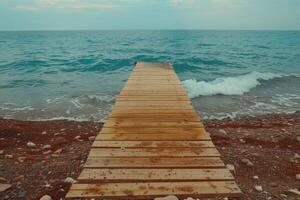 A wooden pier with a blue and white color scheme. The pier is located in the ocean and is surrounded by water. The image has a calm and peaceful mood, as it captures the beauty of the photo