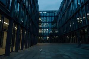 Modern office building windows lit in evening night early morning long working hours exhaustion overtime exterior urban architecture skyscraper lights tower financial sector banking hq photo