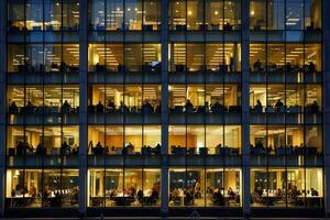 Modern office building windows lit in evening night early morning long working hours exhaustion overtime exterior urban architecture skyscraper lights tower financial sector banking hq photo