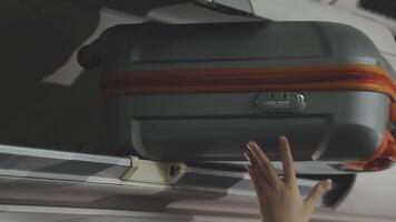 An Asian businesswoman in a semi-formal suit is using a tablet to read and analyze business data while traveling to a meeting in business class on a plane. video