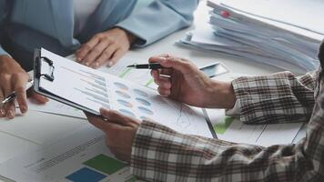 Team of business people working together in the meeting room office, teamwork background charts and graphs banner, double exposure successful teamwork,business planning concept. video