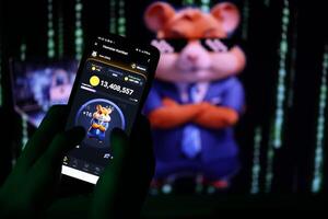 KYIV, UKRAINE - APRIL 20, 2024 Hamster Kombat telegram bot on smartphone screen. Hamster Kombat is a viral Telegram-based crypto game for earn HMSTR tokens by managing virtual crypto exchange photo