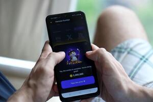 KYIV, UKRAINE - APRIL 20, 2024 Hamster Kombat telegram bot on smartphone screen. Hamster Kombat is a viral Telegram crypto game for earn HMSTR tokens by managing virtual crypto exchange photo
