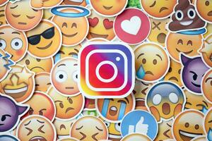 KYIV, UKRAINE - APRIL 20, 2024 Instagram logo and large set of stickers with Emoji yellow faces. Emoji is a pictogram or smiley embedded in text and used in electronic messages photo