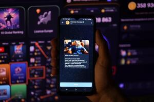 KYIV, UKRAINE - APRIL 20, 2024 Hamster Kombat telegram bot on smartphone screen. Hamster Kombat is a viral Telegram-based crypto game for earn HMSTR tokens by managing virtual crypto exchange photo